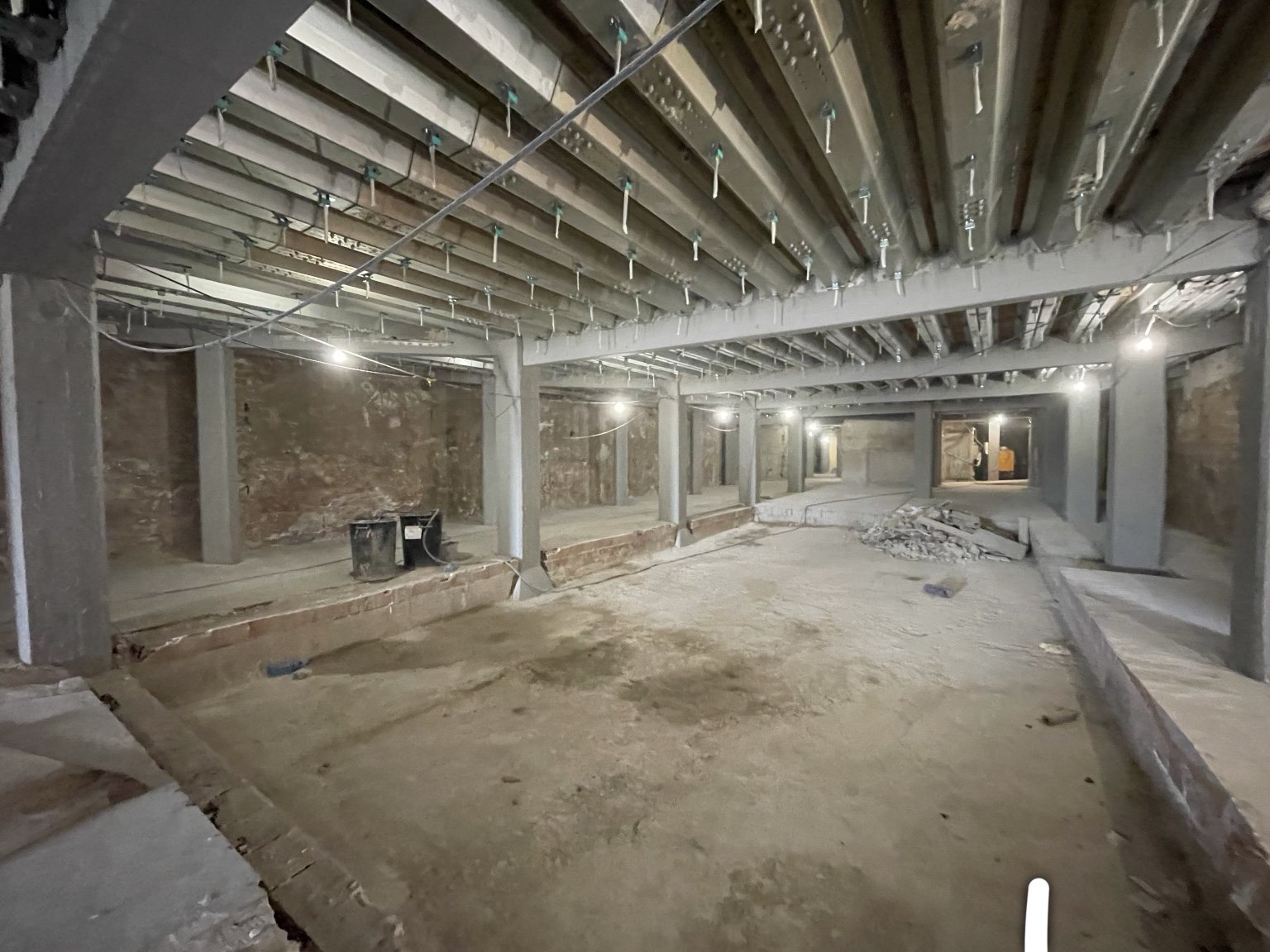 The same room today: 800 square metres of stripped shell, the steel we keep