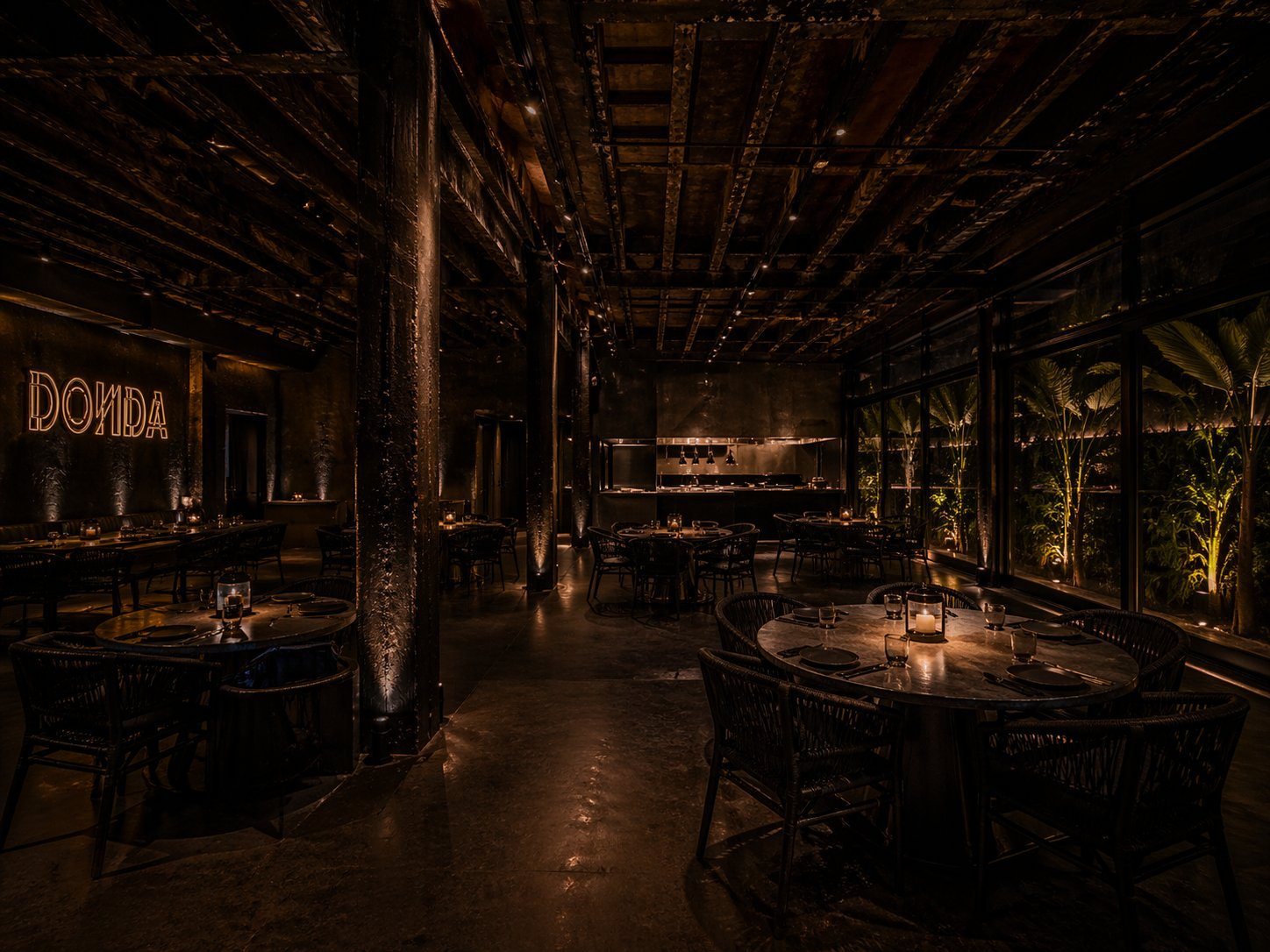 Render: the dining room at night, the garden beyond the glass