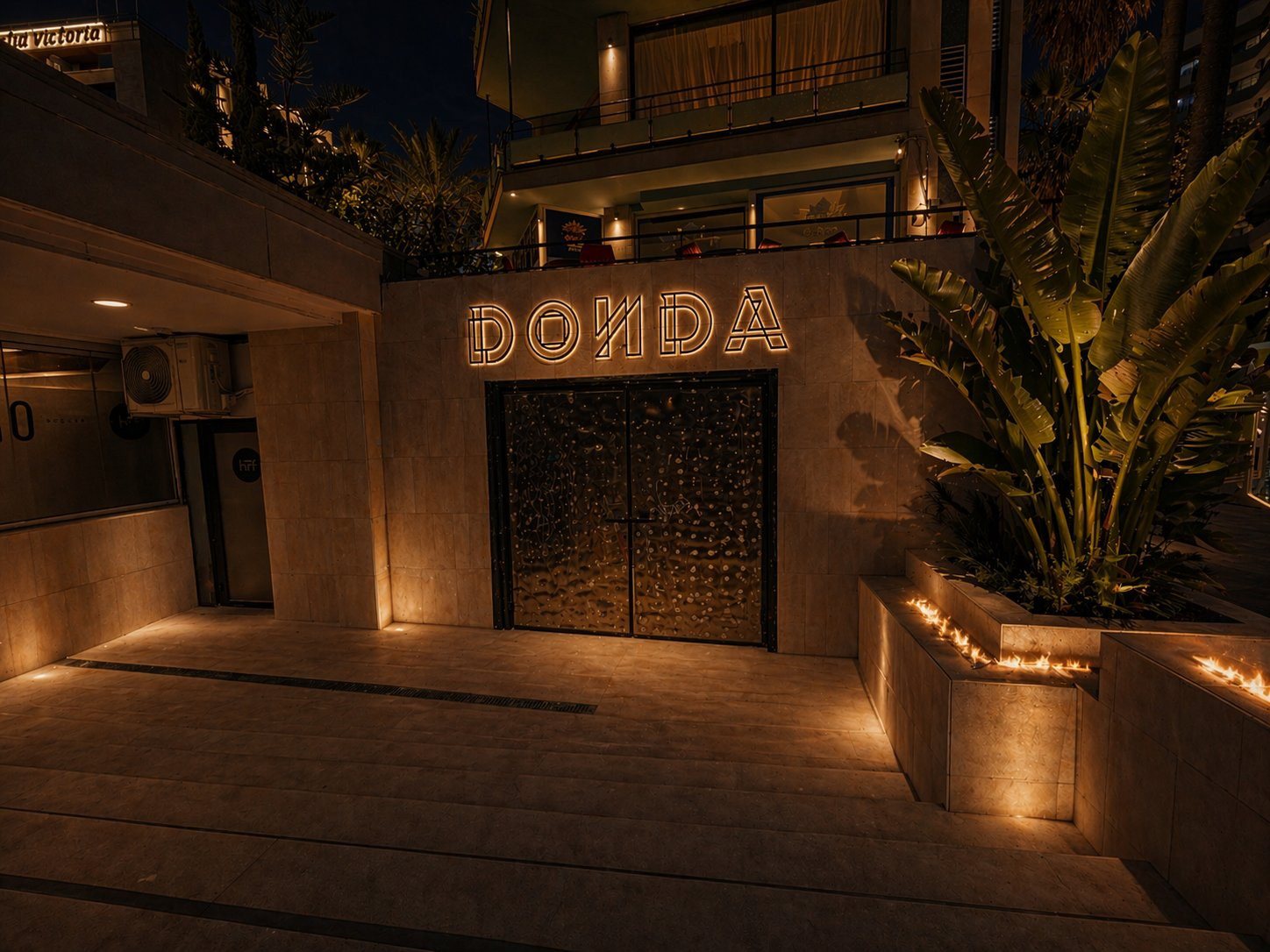 The DONDA doors at night, the neon lit above them